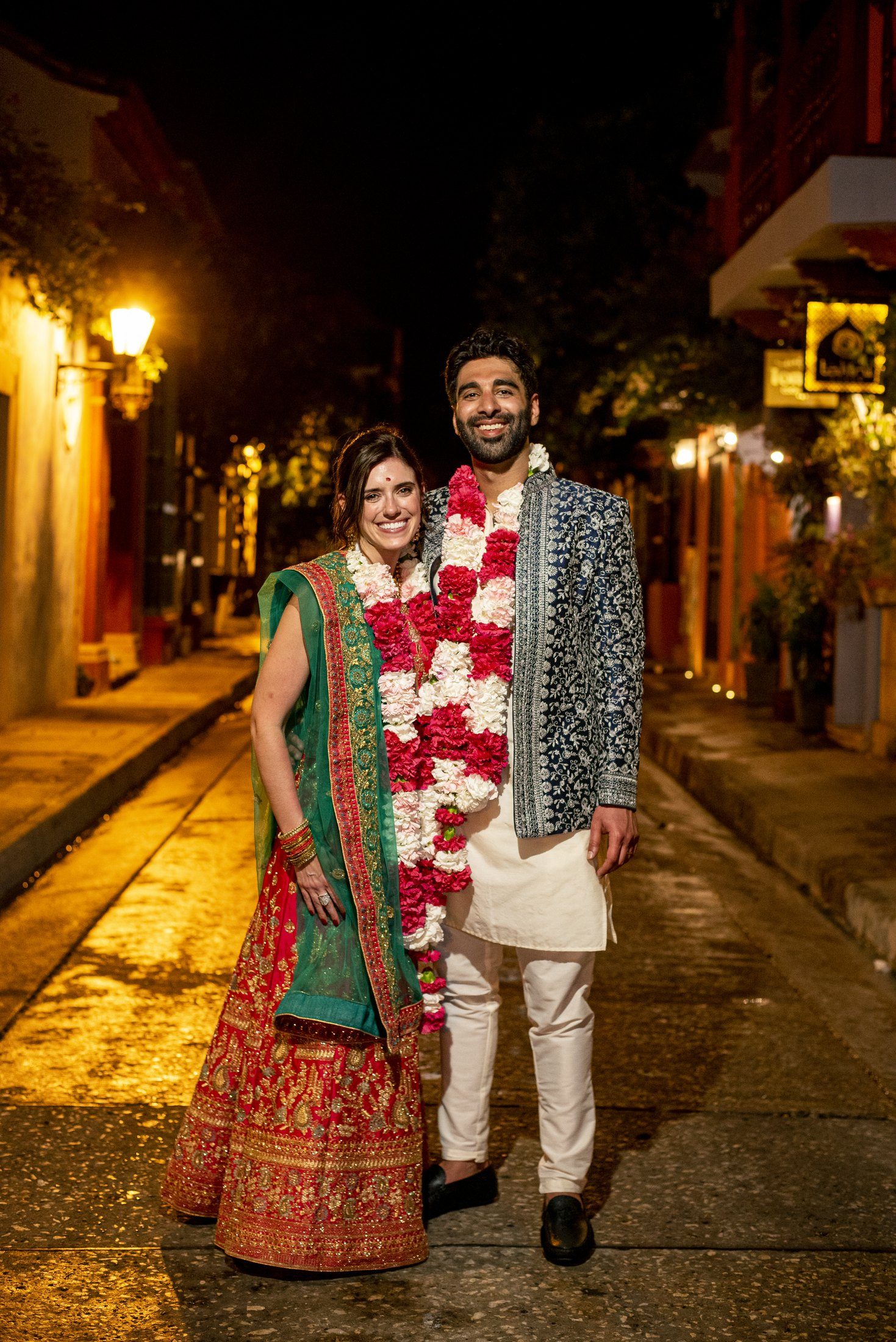 Couple in Indian wedding attire on a colonial street in Cartagena at golden hour